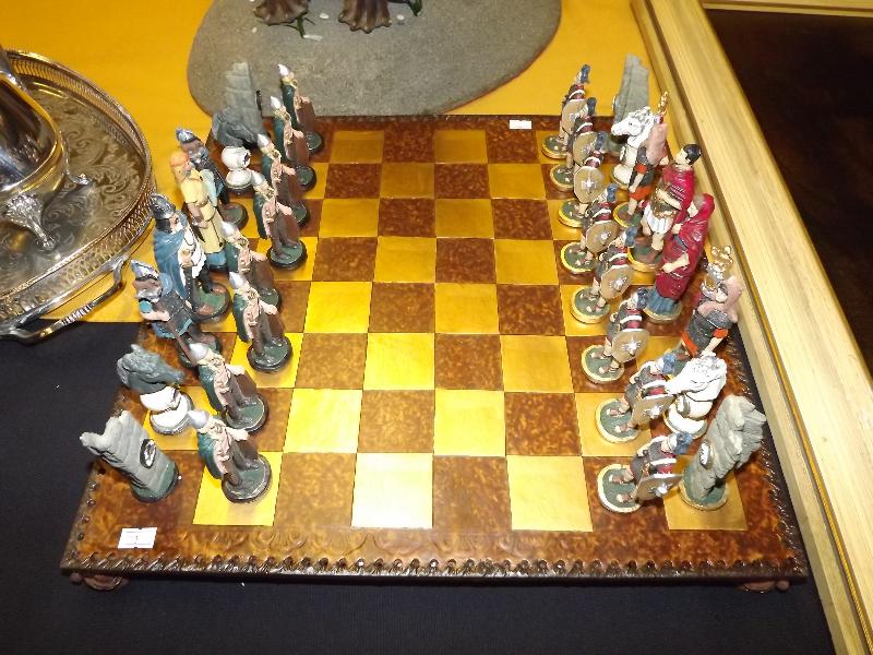 A complete set of chess pieces in period costume on a chess board