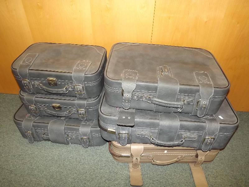 A collection of graduated suitcases and one other