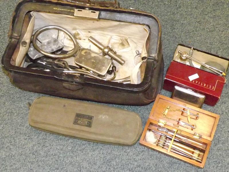A doctor's mid century case containing a large collection of medical instruments of the period