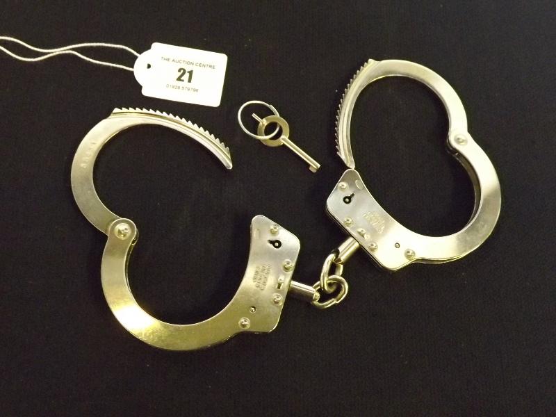 A pair of chain style steel restraints / handcuffs marked 'Hiatts, made in England' serial no. 58431