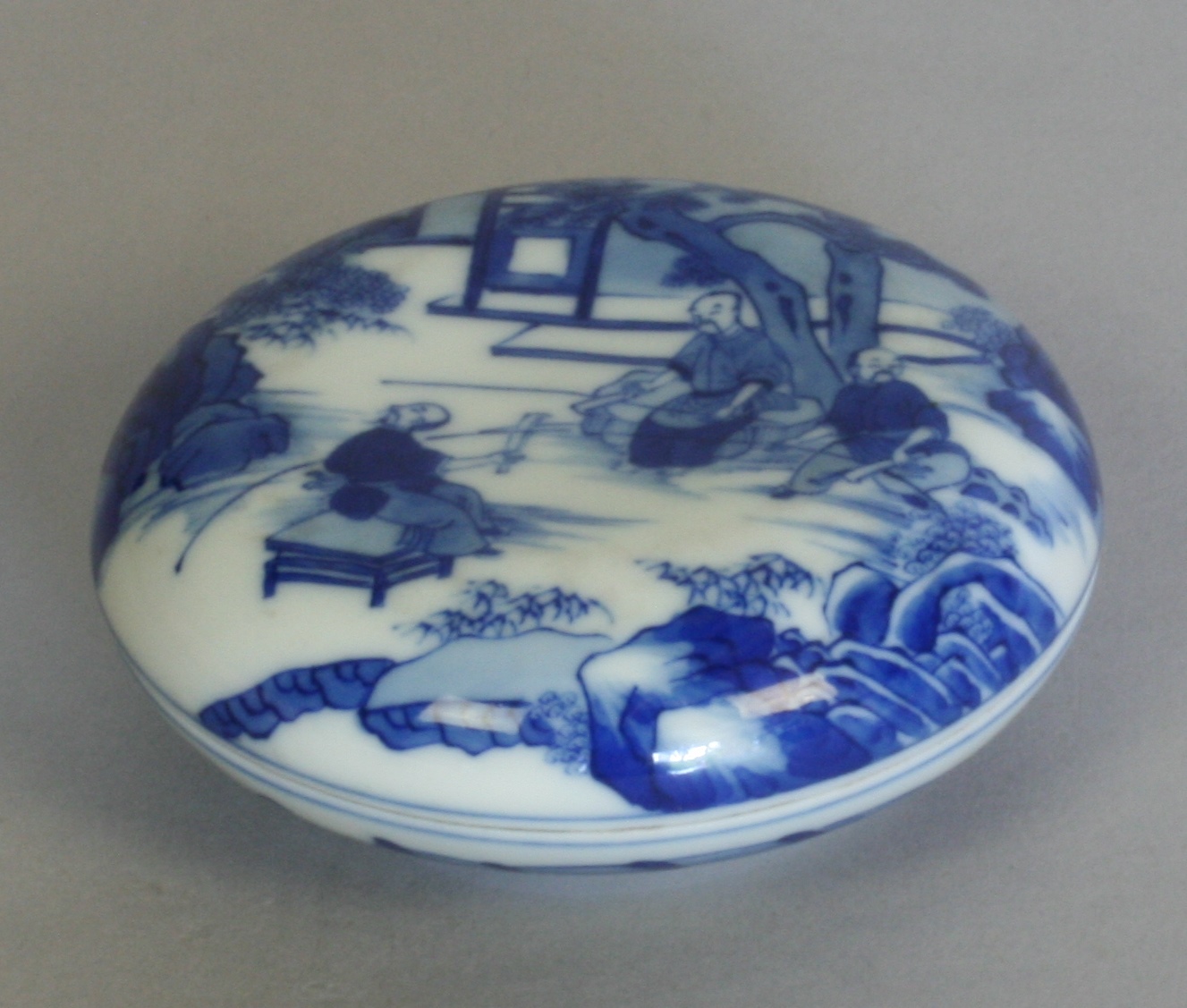 A Chinese Blue and Bowl with cover. 19th century. Decorated with figures in a garden. Under glaze