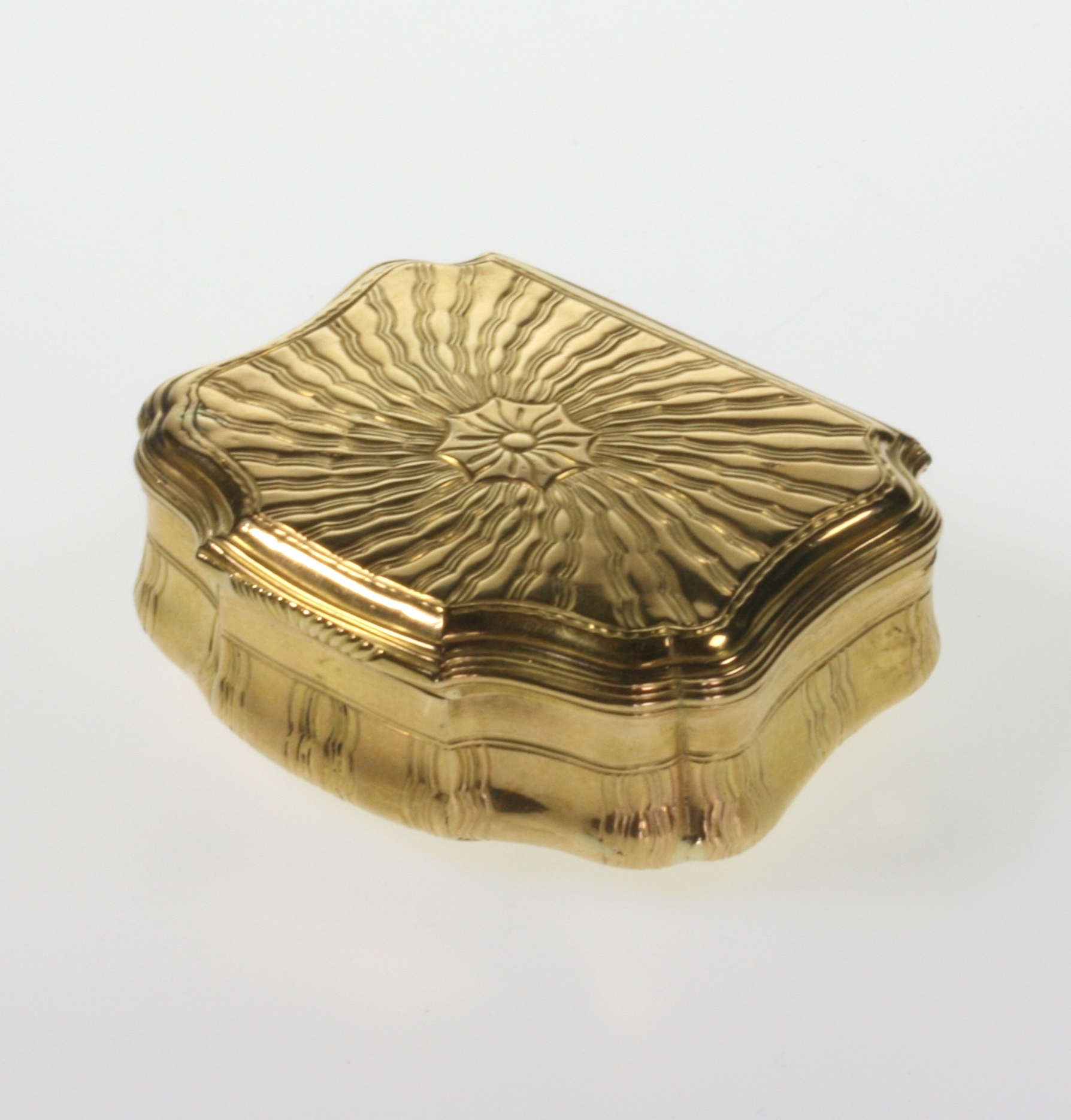 A Fine Gold Snuff Box. Probably French. Circa 1740. Of shaped rectangular form. The hinged cover and