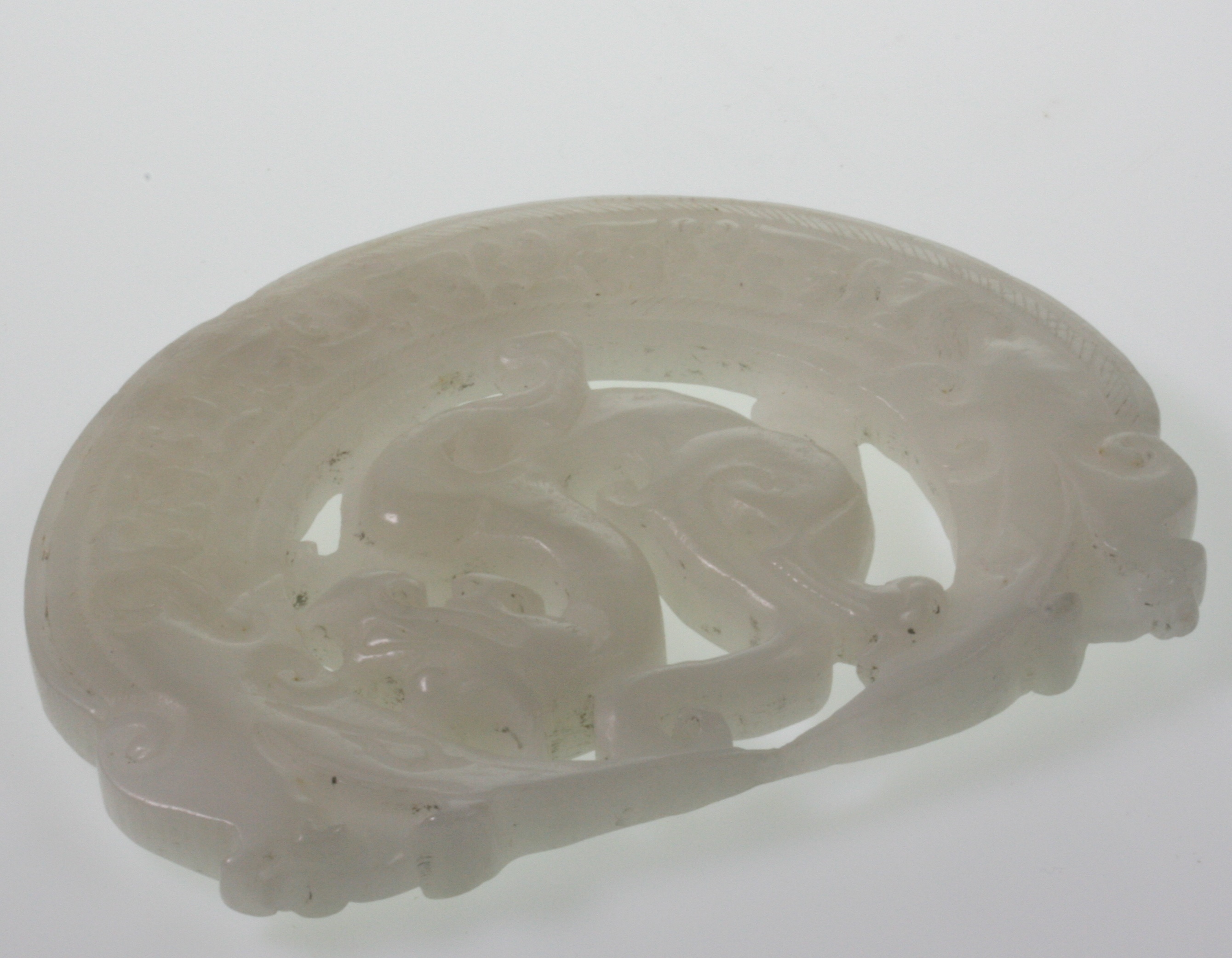 A Chinese Imperial White Jade Medallion. Probably 18th century. Originally of circular form but with