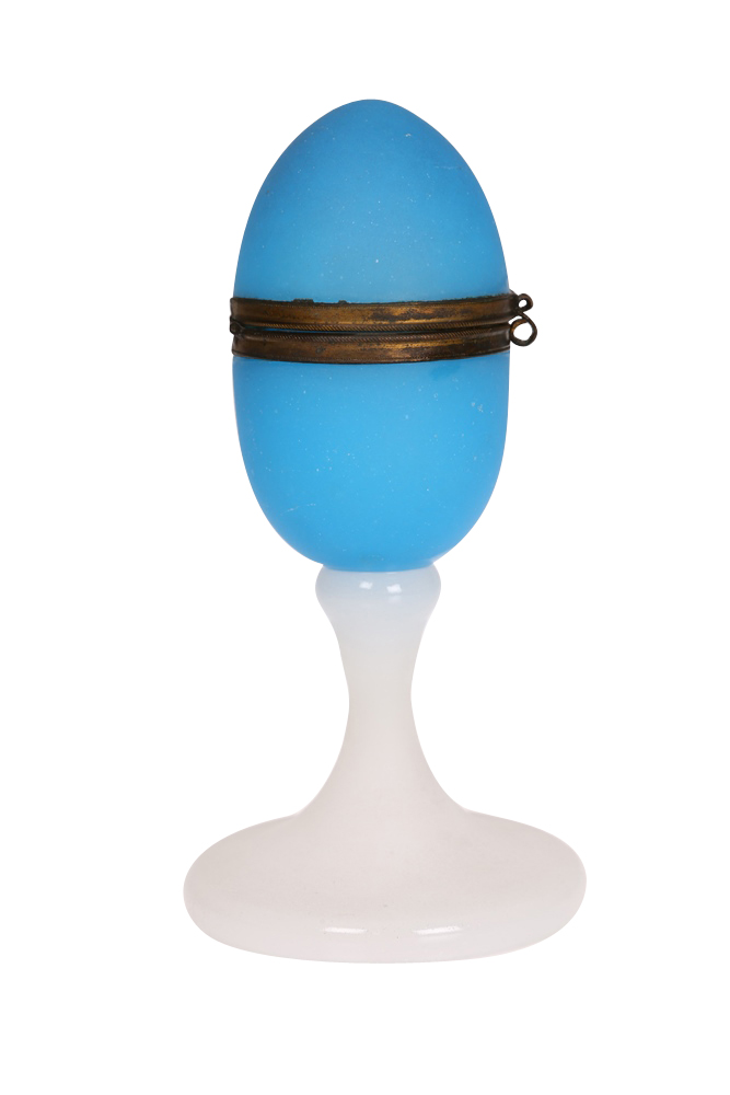 A 19th Century blue glass jewel box on stand, the egg-form brass-mounted box with hinged cover,