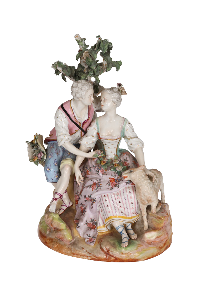 A Continental porcelain figure group, the lovers modelled and painted in 18th Century dress, sitting