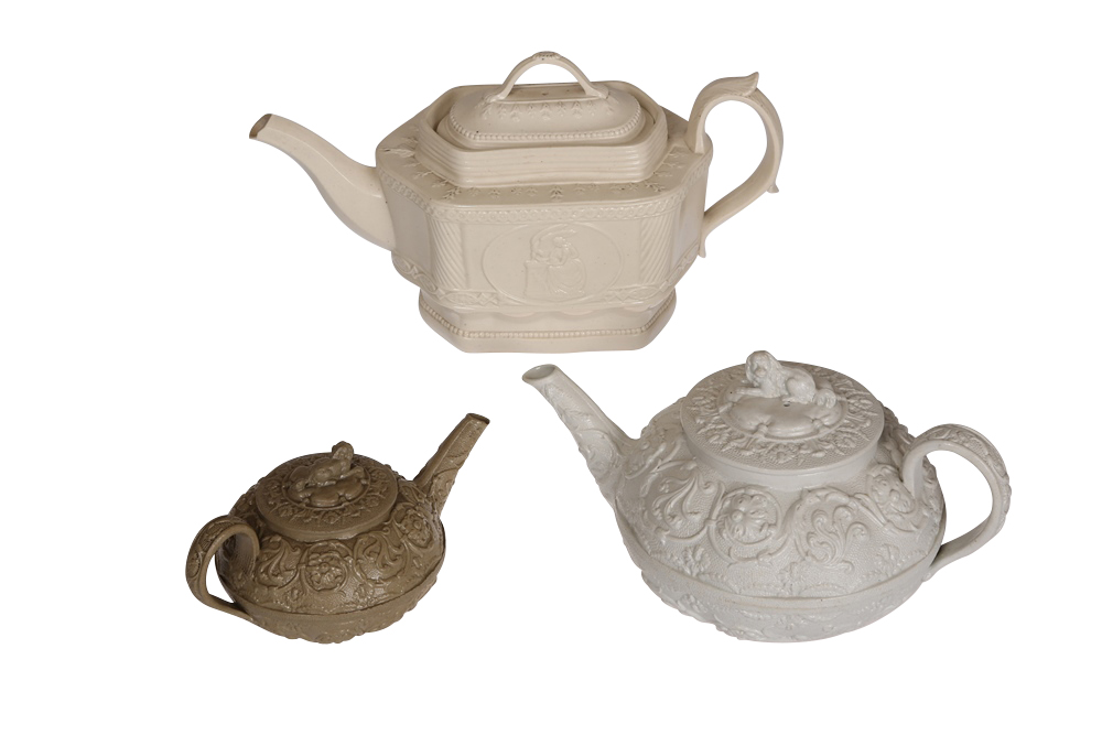 A Wedgwood white stoneware teapot, moulded in relief with scrolling foliage, the cover with King