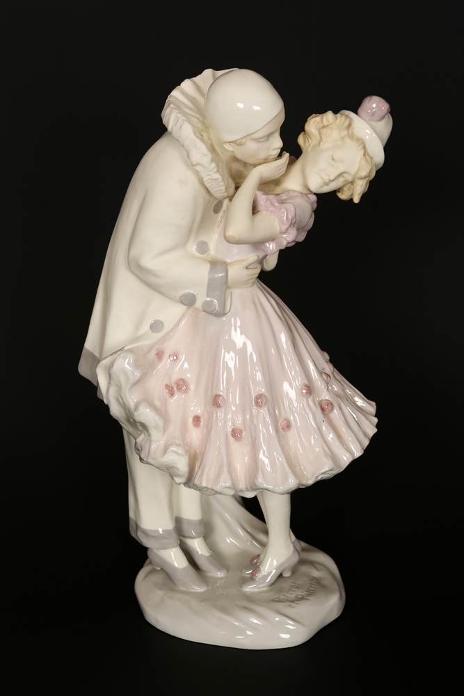 An early 20th Century faience figural lamp base, modelled as Pierrot and Pierrette, signed Podany,