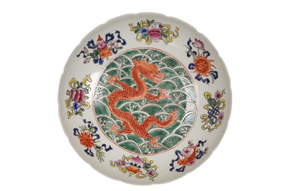 A small Chinese porcelain dish, circular with crenellated rim, principally enamel painted with