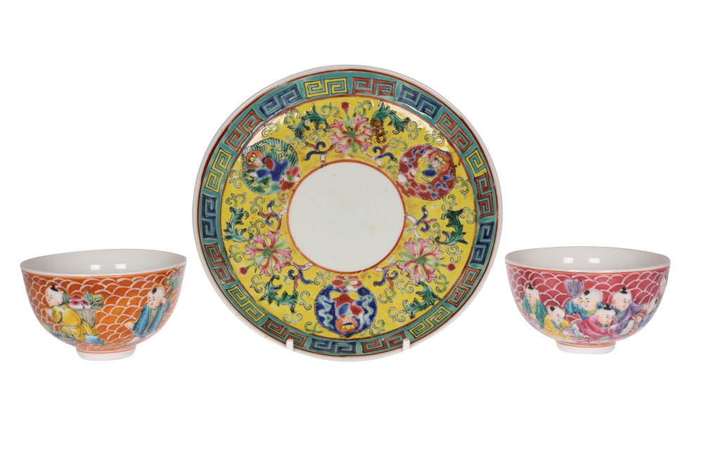 Two Chinese porcelain wine cups, each enamel painted with figures against a scaled ground, each