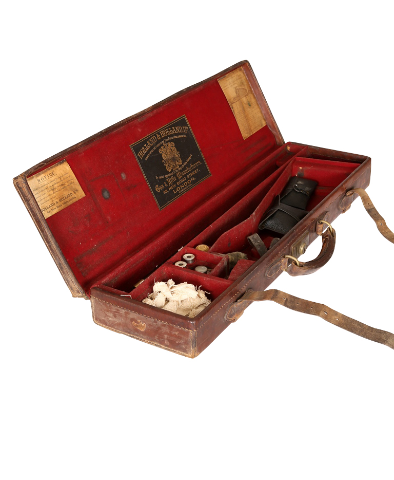 A Holland & Holland leather gun case, the paper label to underside of the lid, titled ROYAL