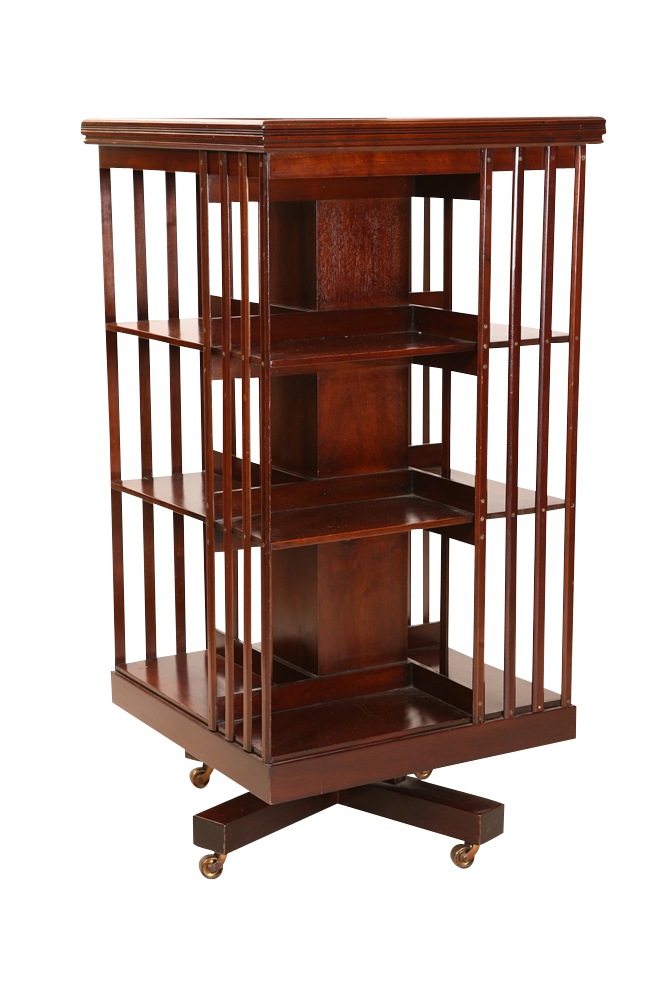A mahogany revolving bookcase, early 20th Century, the square moulded top above three tiers and