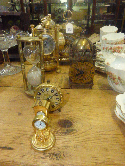 Three brass clocks, three small clocks and egg timer (9)