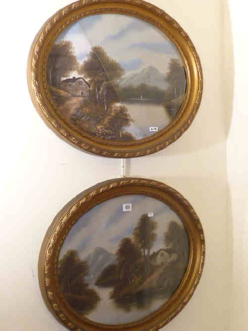 Pair of oval oil paintings of mountainous landscapes in gilt frames