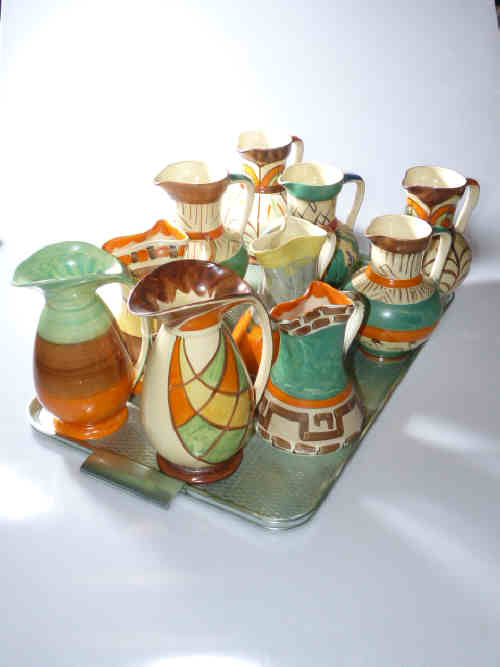 Collection of ten Myott hand-painted 1930's pottery jugs including two Dante jugs with chicken