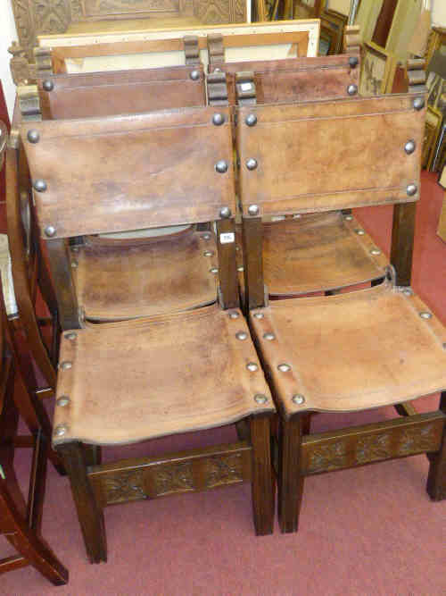 Set of four hide seat and panel back dining chairs