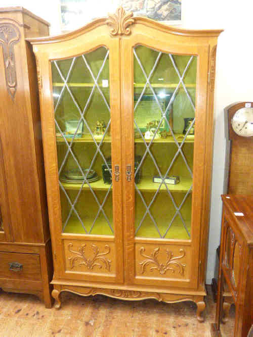 French oak arched top leaded glazed door bookcase on cabriole legs