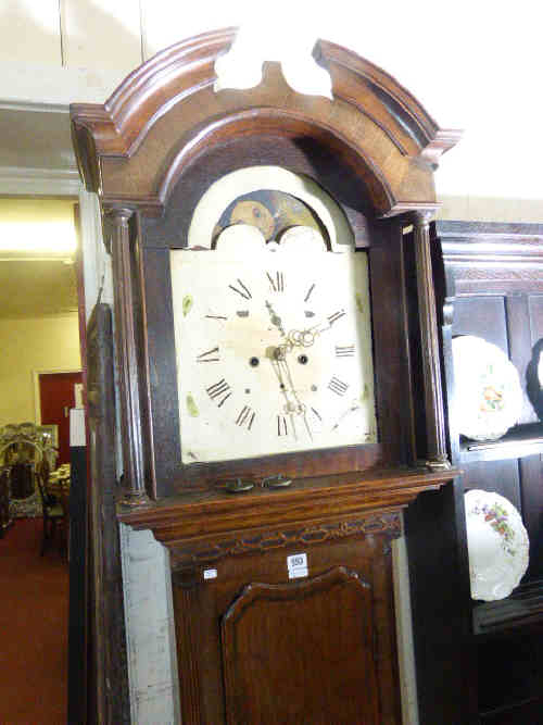 Antique oak eight day longcase clock having painted arched moon phase dial