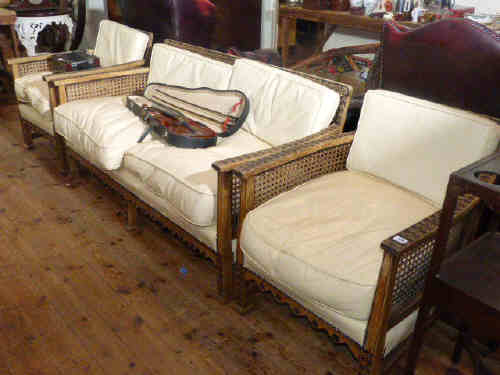 Early 20th century carved oak bergere panelled three piece lounge suite