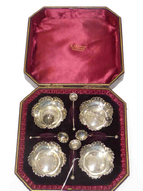 Cased set of four silver open salts and spoons