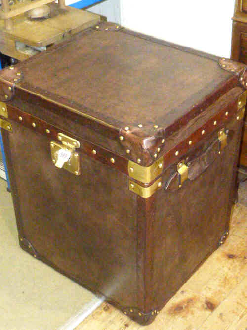 Brown leather trunk with carrying handles
