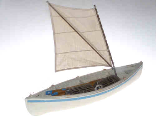 A wooden model of a Whitby cobble complete with sail, oars and lobster pots