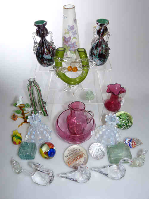 Tray of collectable glassware including paperweights, vases, two cranberry glass cream jugs and