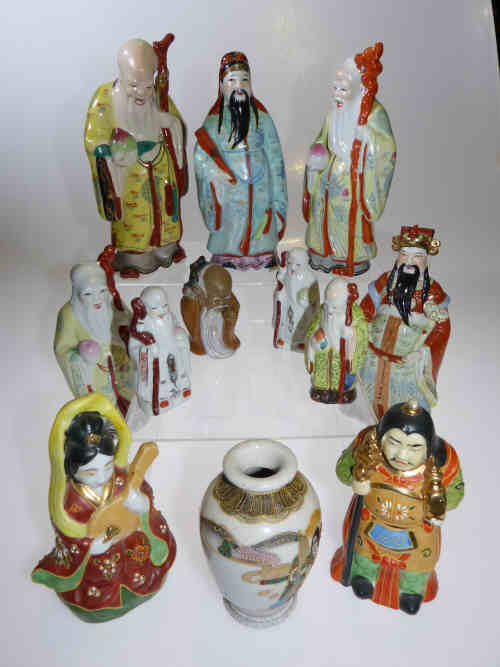 Eleven Japanese pottery figurines and a small vase