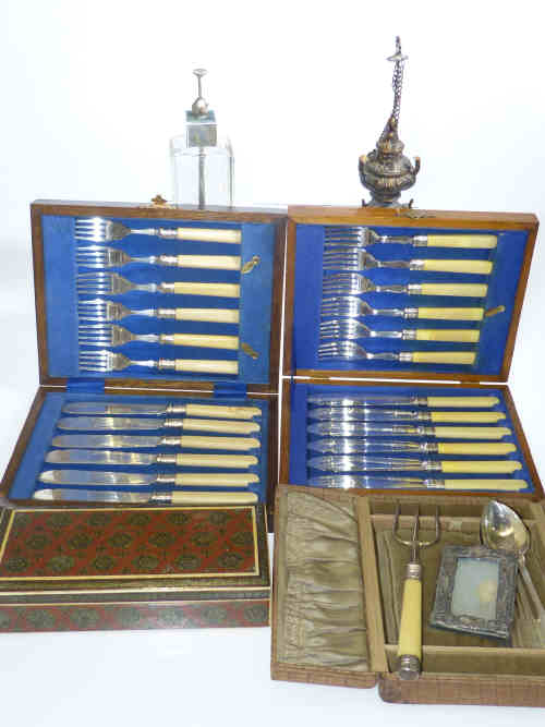 Two boxes of fish knives and forks, six teaspoons, bread fork, small photograph frame, silver