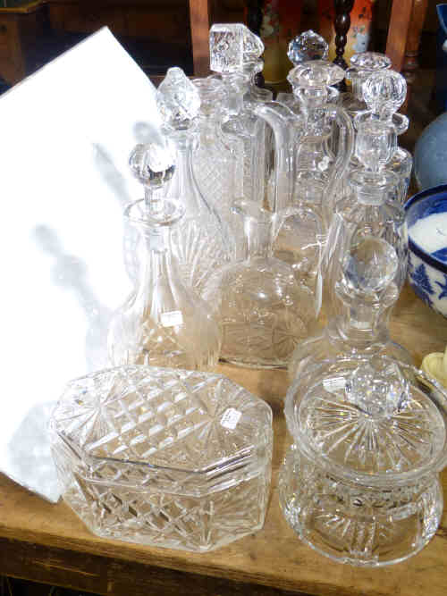 A collection of thirteen cut glass decanters and two biscuit barrels (15)