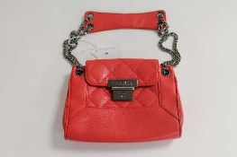 A Chanel red leather hand bag, with authenticity card no. 8922961.   CONDITION REPORT:  Good