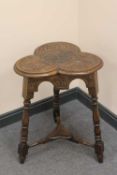 An Edwardian carved oak clover-leaf table.   CONDITION REPORT:  Good condition.