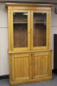 An Edwardian ash bookcase, width 130 cm.   CONDITION REPORT:  Fair condition, some problem areas