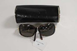 A pair of Bulgari sunglasses, in cylindrical case.   CONDITION REPORT:  Good/Fair condition, the