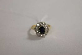 An 18ct gold diamond and sapphire cluster ring.   CONDITION REPORT:  Good condition.