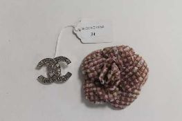 A Chanel faux diamond brooch, together with a cloth flower brooch of the same manufacture. (2)