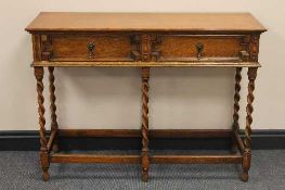 An Edwardian carved oak two drawer side table, width 107 cm.   CONDITION REPORT:  Good condition.