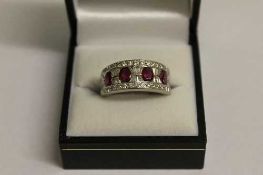 An 18ct white gold diamond and ruby ring.   CONDITION REPORT:  Good condition.