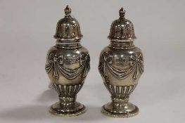 A pair of silver pepperettes, Sheffield 1859 by Walker and Hall. (2)   CONDITION REPORT:  Good