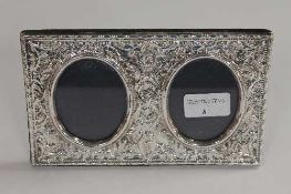 A silver embossed twin photograph frame, Birmingham 1994, width 20 cm.   CONDITION REPORT:  Good