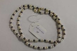 A double strand of two-tone cultured pearls with 9ct gold clasp.   CONDITION REPORT:  Good
