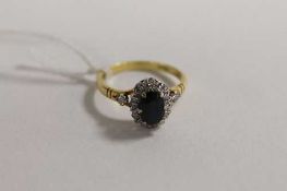 An 18ct gold diamond and sapphire ring.   CONDITION REPORT:  Good condition.