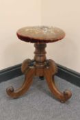 An early Victorian rosewood revolving embroidered adjustable stool.   CONDITION REPORT:  Good