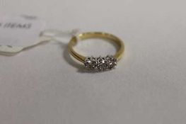 An 18ct gold three stone diamond ring.   CONDITION REPORT:  Good condition.