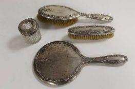 A four piece silver backed dressing table set, Birmingham 1908. (4)   CONDITION REPORT:  Good time
