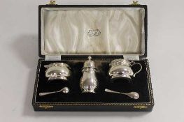 A silver three piece silver cruet set, retailed by Reids of Newcastle upon Tyne, cased.