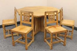An oak octagonal pedestal dining table and four chairs by Robert 'Mouseman' Thompson of Kilburn,