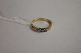 An 18ct gold three stone diamond ring.   CONDITION REPORT:  Good condition.