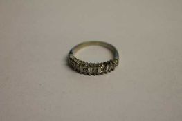A diamond half eternity ring.   CONDITION REPORT:  Good condition the yellow metal shank unmarked.