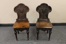 A pair of late Victorian carved oak hall chairs. (2)   CONDITION REPORT:  Good condition, very