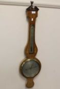 A Victorian barometer in an inlaid mahogany case.   CONDITION REPORT:  Slightly faded but good